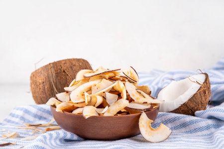 Homemade coconut chips, healthy organic coconut crackers, alternative snack for keto, diet lifestyle, with fresh coconut, copy spaceの写真素材