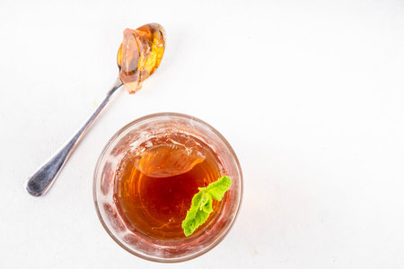 Black tea trendy asian dessert, diet non calorie sweet tea agar or gelatine jelly, in portioned glass, white table background copy spaceの写真素材