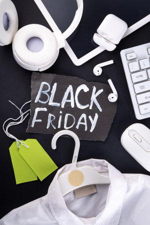 Black friday sale background with sale tags, clothes, laptop, headphones, smartphone, tablet, sale items, flat lay top view copy spaceの写真素材