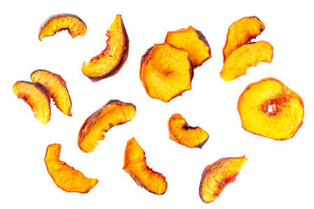 Homemade sun dried sublimated slices of peach, dehydrate peach fruits for eating healthy sweet snacks, fruit chips, ingredient for cooking and desserts. Alternative preservation without sugarの写真素材