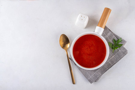 Tasty tomato cream soup. Delicious hot fall season gazpacho creamy pureed soup with garlic and aromatic herbs. Autumn and winter comfort food, tasty vegan vegetable recipeの写真素材