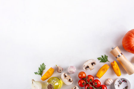 Autumn vegetable preparation dinner background. Food background with organic fresh farm raw veggies, pumpkin, garlic, mushrooms, tomato, greenery, Ingredients for cooking with copy spaceの写真素材