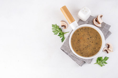 Delicious tasty champignons mushrooms cream soup. Creamy pureed vegetable soup with mushrooms, carrot, herbs. Autumn and winter comfort food, vegan diet recipeの写真素材