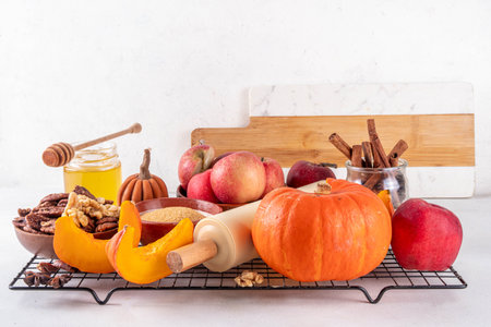 Fall baking, cooking seasonal dessert background with various ingredients - honey, pumpkin squash,...