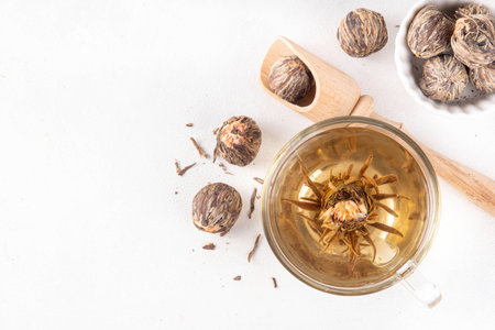 Tea Blossoms, dried Blooming Tea in glass cup on white table copy spaceの写真素材
