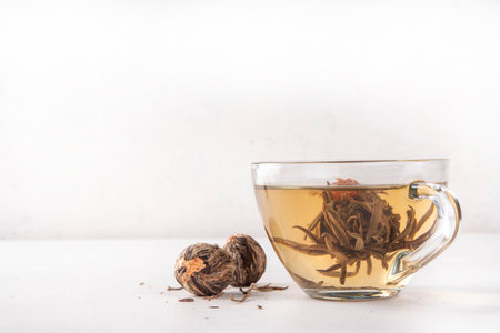 Tea Blossoms, dried Blooming Tea in glass cup on white table copy spaceの写真素材