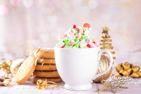 Festive tasty Christmas hot chocolate with green and red colored whipped cream, with marshmallow and...