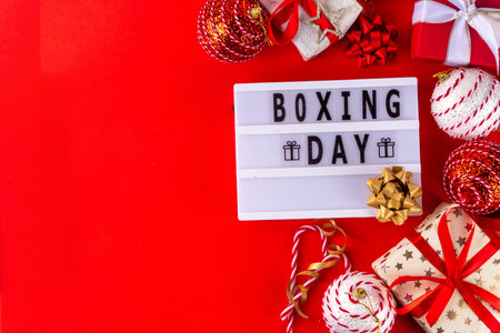Boxing day sale seasonal promotion background with various wrapped presents gift boxes, baubles, ribbon, with inscription frame Boxing day, Christmas decor, ribbonsの写真素材