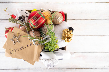 Donating gifts and toys to charity for Christmas holiday concept. Tradition holiday toys drive, cardboard box full with with kids toys, gifts, Christmas decorations, baubles and sweets, copy spaceの写真素材