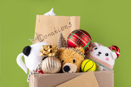 Donating gifts and toys to charity for Christmas holiday concept. Tradition holiday toys drive, cardboard box full with with kids toys, gifts, Christmas decorations, baubles and sweets, copy spaceの写真素材