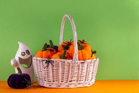 Happy Halloween holiday background with colorful pumpkins and holiday symbols decor, spiders, witch hat, bat, black cats, ghost, candies, candy corn on bright background top view copy spaceの写真素材