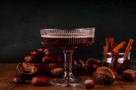 Strong alcohol chestnut martini cocktail, autumn dark and spicy alcoholic drink in martini glass with chestnut liquor and cinnamonの写真素材