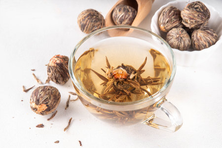 Tea Blossoms, dried Blooming Tea in glass cup on white table copy spaceの写真素材