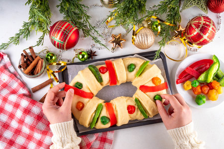 Cooking traditional Mexican Rosca de Reyes, baking for January 6th in honor of DÃ­a de los Reyes Magos, Three Kings Bread, fruit flavored sweet bread for Christmas and  Kings Day festivitiesの写真素材