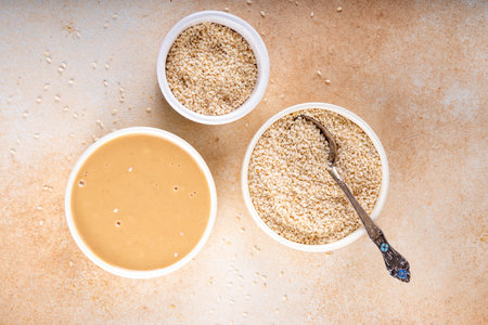 Tahini with sesame seeds, oily sesame paste, source of healthy fats, snack or ingredient in Middle...