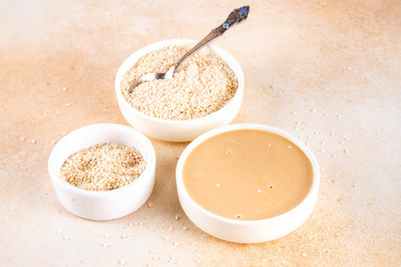 Tahini with sesame seeds, oily sesame paste, source of healthy fats, snack or ingredient in Middle...