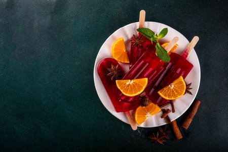 Tasty winter mulled wine ice cream popsicles. Frozen mulled wine cocktail on sticks, traditional...