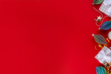 Red and white Christmas, New Year background with christmas tree balls and decorations, holiday gift boxes, baubles, flat lay on pink background copy spaceの写真素材