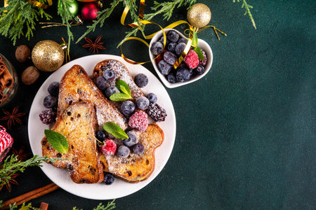 Leftover Christmas Spiced Stollen French Toasts, sweet fried stollen toasts with sugar powder and berries, Christmas morning dessert snackの写真素材