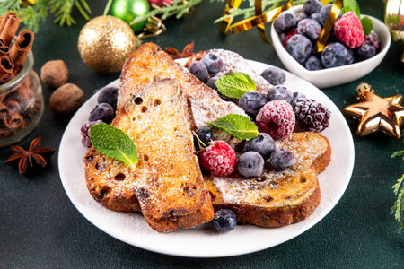 Leftover Christmas Spiced Stollen French Toasts, sweet fried stollen toasts with sugar powder and berries, Christmas morning dessert snackの写真素材