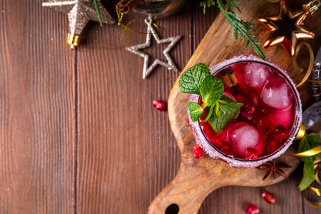 Spiced up winter berry Margarita cocktail or mocktail with orange, cranberry, pomegranate mint and crushed ice, Sweet non-alcohol or alcohol vodka drink for Christmas partyの写真素材