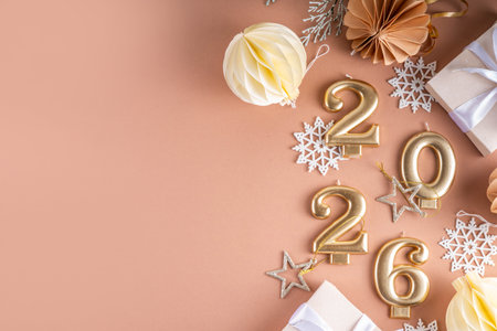 New year 2026 celebration greeting card background Gold numbers 2026 with golden party decoration, stars confetti on pink background. Flat lay, Merry Christmas, Noel happy New Year holidays bannerの写真素材