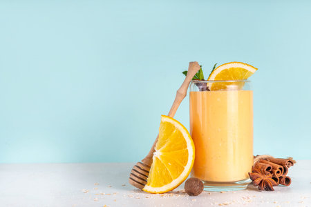 Autumn winter spicy fruit smoothie set. Various flavor tasty smoothie drinks in 3 glasses with yogurt, oats, seasonal fruits - apple, orange, cranberry, with anise and cinnamonの写真素材