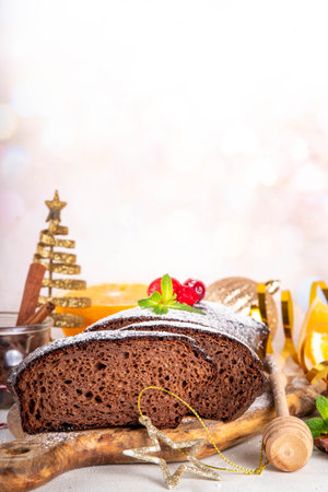 Homemade gingerbread loaf cake. Freshly baked Christmas Gingerbread chocolate cake with sugar powder topping, on white festive decorated backgroundの写真素材