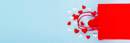 Valentine day sale and shopping background . Red paper shopping bag with text sale, white, red, gold hearts. Simple minimal Valentines greeting card, invitation, marketing promo mockup copy spaceの写真素材