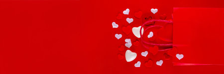 Valentine day sale and shopping background . Red paper shopping bag with text sale, white, red, gold hearts. Simple minimal Valentines greeting card, invitation, marketing promo mockup copy spaceの写真素材