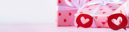 Cute pink background for Valentine Day. Valentines greeting card flat lay with gifts box with...