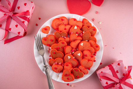 Sweet cute sign of love on Valentine's Day, lovely breakfast, snack with red velvet pancakes in form of hearts, with sugar sprinkled hearts and berry. Simple food idea for Valentine's Day surprise giftの写真素材