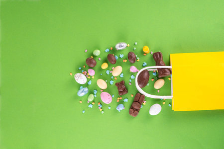 Easter sweets and candies shopping background with chocolate Easter eggs, bunny rabbits, sugar...