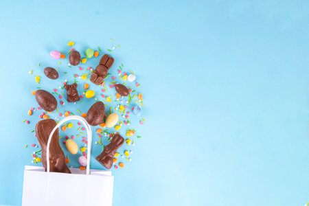 Easter sweets and candies shopping background with chocolate Easter eggs, bunny rabbits, sugar...