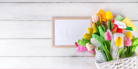 Spring cleaning background with spring flowers and cleaning utensils in white basket, Various household supplies, bottles, accessories, with blossom tulips, spring cleaning sale promotion copy spaceの写真素材