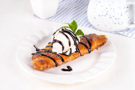 Trendy viral korean style flat croissant with ice cream and chocolate sauce, sweet sugared caramel...