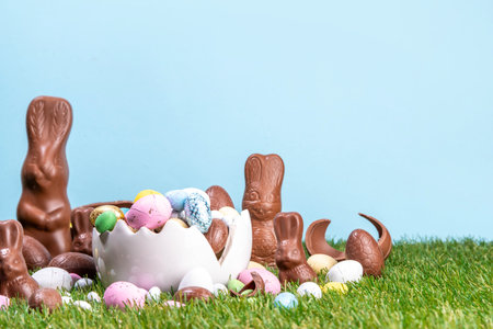 Easter egg hunting background with chocolate eggs. Various candy and chocolate Easter eggs, bunny...