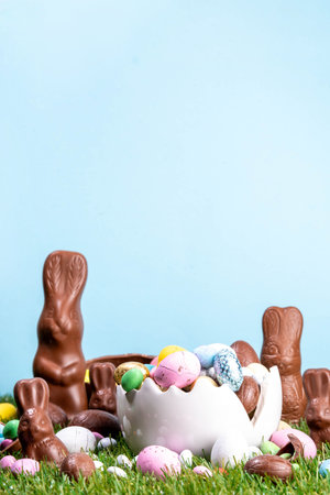 Easter egg hunting background with chocolate eggs. Various candy and chocolate Easter eggs, bunny...