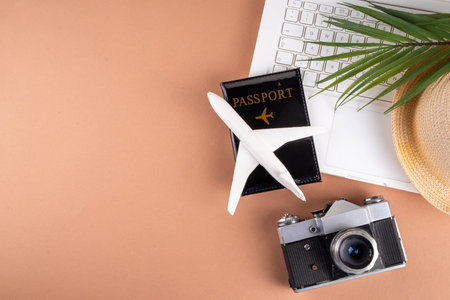 Summer work and travel background, white laptop with documents, ticket, airplane and photo camera on...