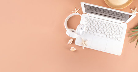Summer work and travel background, white laptop with documents, ticket, airplane and photo camera on...