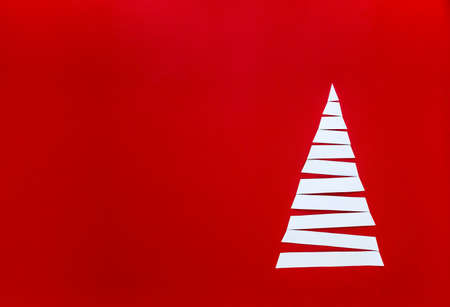 on a red background white paper strips lined herringboneの写真素材