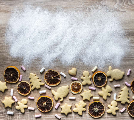a wooden table is sprinkled with flour, and ginger breads are laid out from below as a tree of...