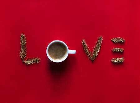 on a red background the word love instead of letters about a mug with coffeeの写真素材