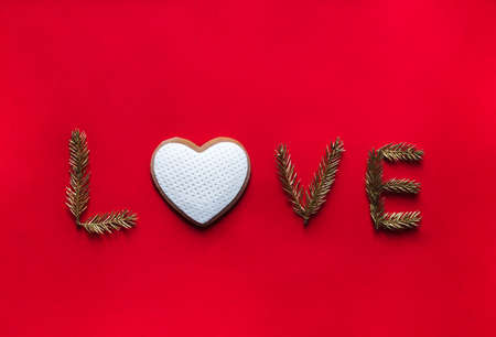 on a red background the word love instead of letters about cookies in the form of a heartの写真素材