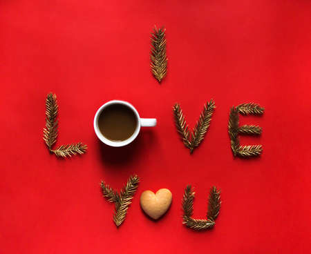 on a red background inscription I love you instead of letters about a cup of coffee and cookies in the form of heartsの写真素材