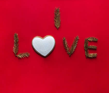 on a red background the inscription I love instead of the letter about cookies in the form of a heartの写真素材