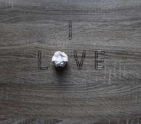 on the wooden background is a clip of love, instead of letters o a piece of paper mintの写真素材