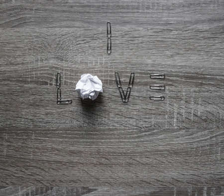 on the wooden background is a clip of love, instead of letters o a piece of paper mintの写真素材