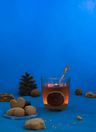 cup of tea with lemon on a blue background night book cookie candle heartの写真素材