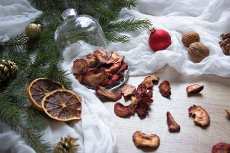 Dried fruits berries strawberries strawberries candied fruits on a table under a glass cap tree cones nuts tissueの写真素材